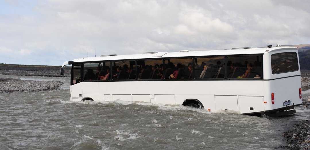Bus crossing the Krossá River on the way to Þórsmörk Iceland